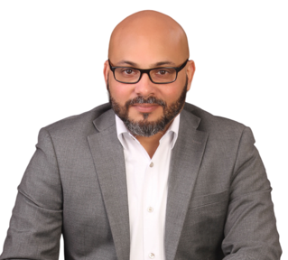 Ivan Roman Cardona wearing a gray suit